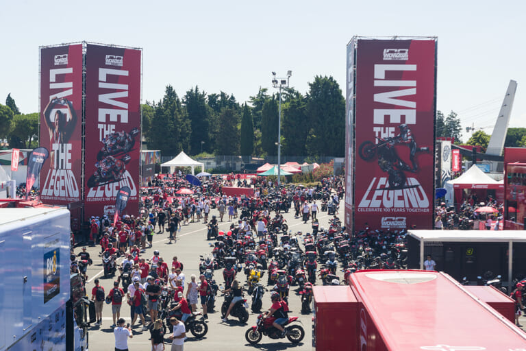 WDW会場、入場ゲート付近の様子。会場内のそこかしこにバイクを駐車可能で、会場全体がドゥカティ・ミュージアムと化す。|来場12万人、パレードは驚異の18km!ドゥカティ100周年記念の『WDW2026』が史上最高のド迫力【マルケス、バニャイア、ストーナーも】