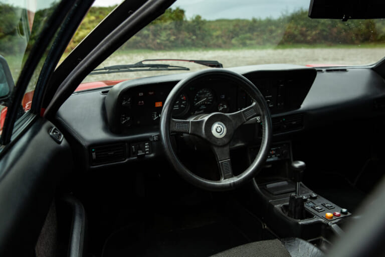 1980年 BMW M1 レッド コクピット インパネ ステアリング｜BMWの黒歴史「鳴かず飛ばずだった46年前の名車」倒産寸前のランボとコラボ開発のはずが…途中でブチ切れ提携解消。個性的なデザインが印象的なモデルを紹介